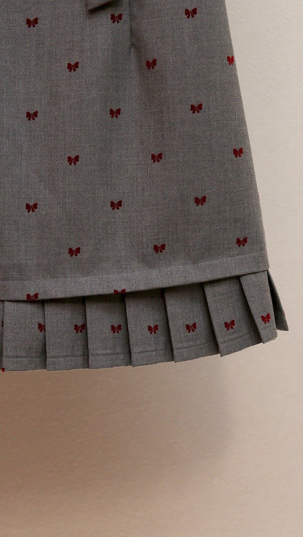 AIIZIE HARUYE PLAYFUL BOW PRINT SLEEVELESS MINI DRESS | SCALLOPED V-NECK & PLEATED HEM - product image