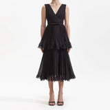 NANCY SLEEVELESS PLEATED TIERED MIDI DRESS IN BLACK