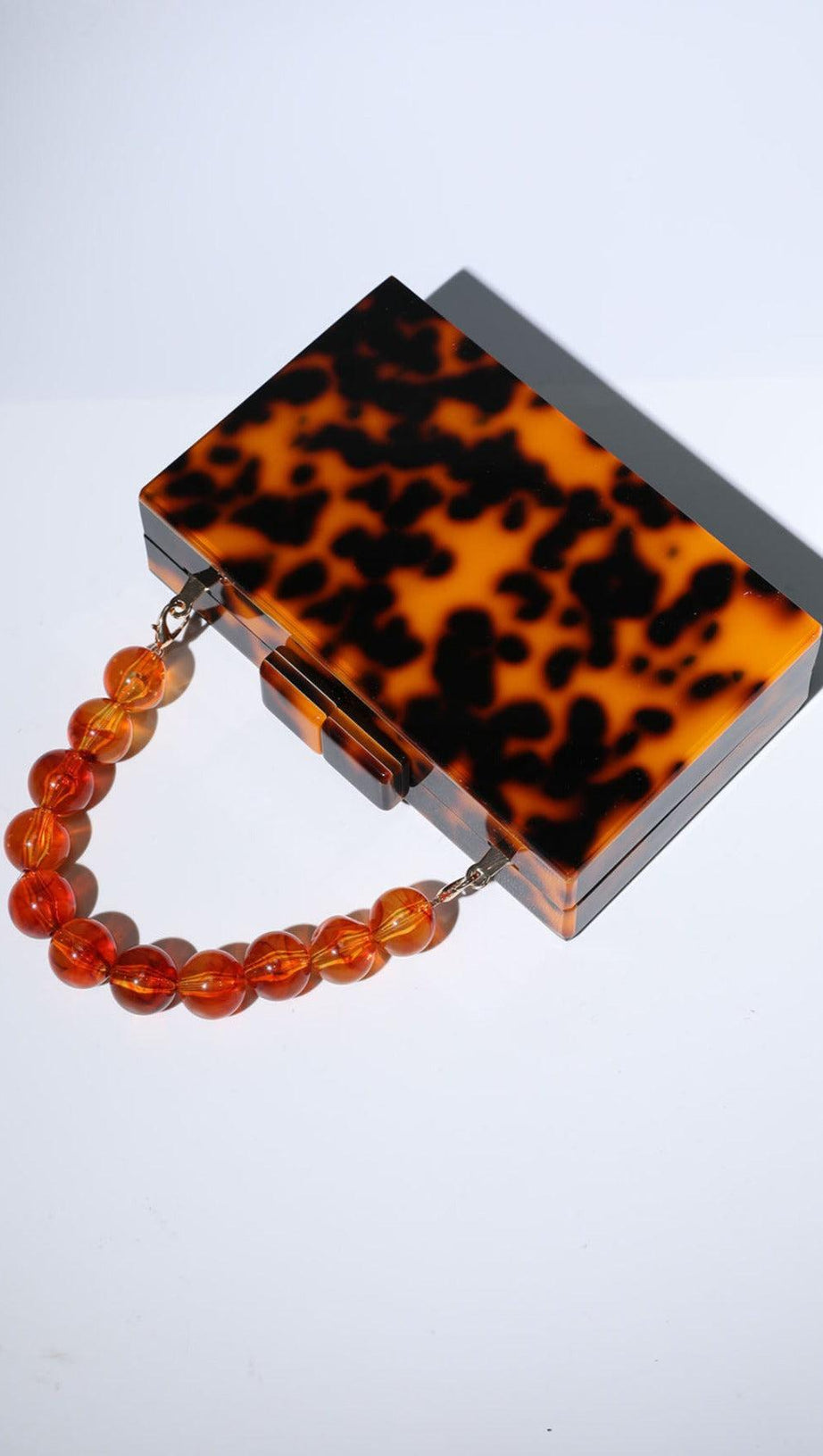 ACRYLIC BEADED CLUTCH IN AMBER