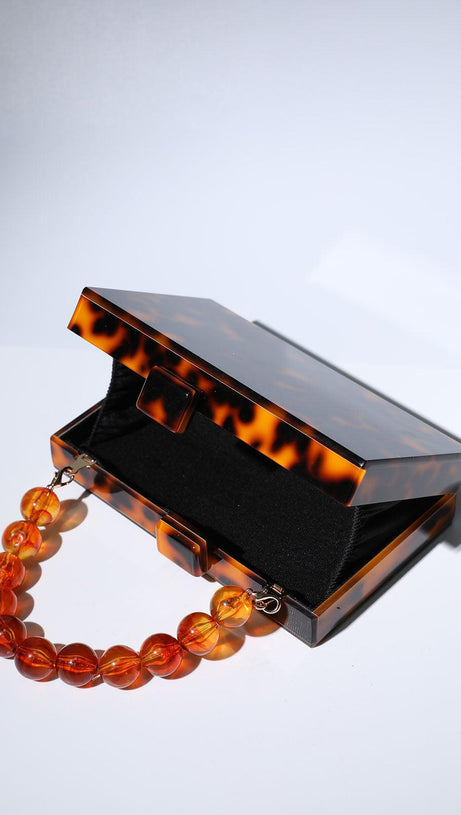 ACRYLIC BEADED CLUTCH IN AMBER