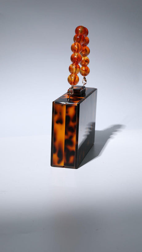 ACRYLIC BEADED CLUTCH IN AMBER