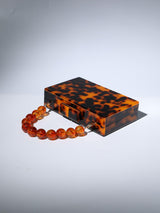 ACRYLIC BEADED CLUTCH IN AMBER